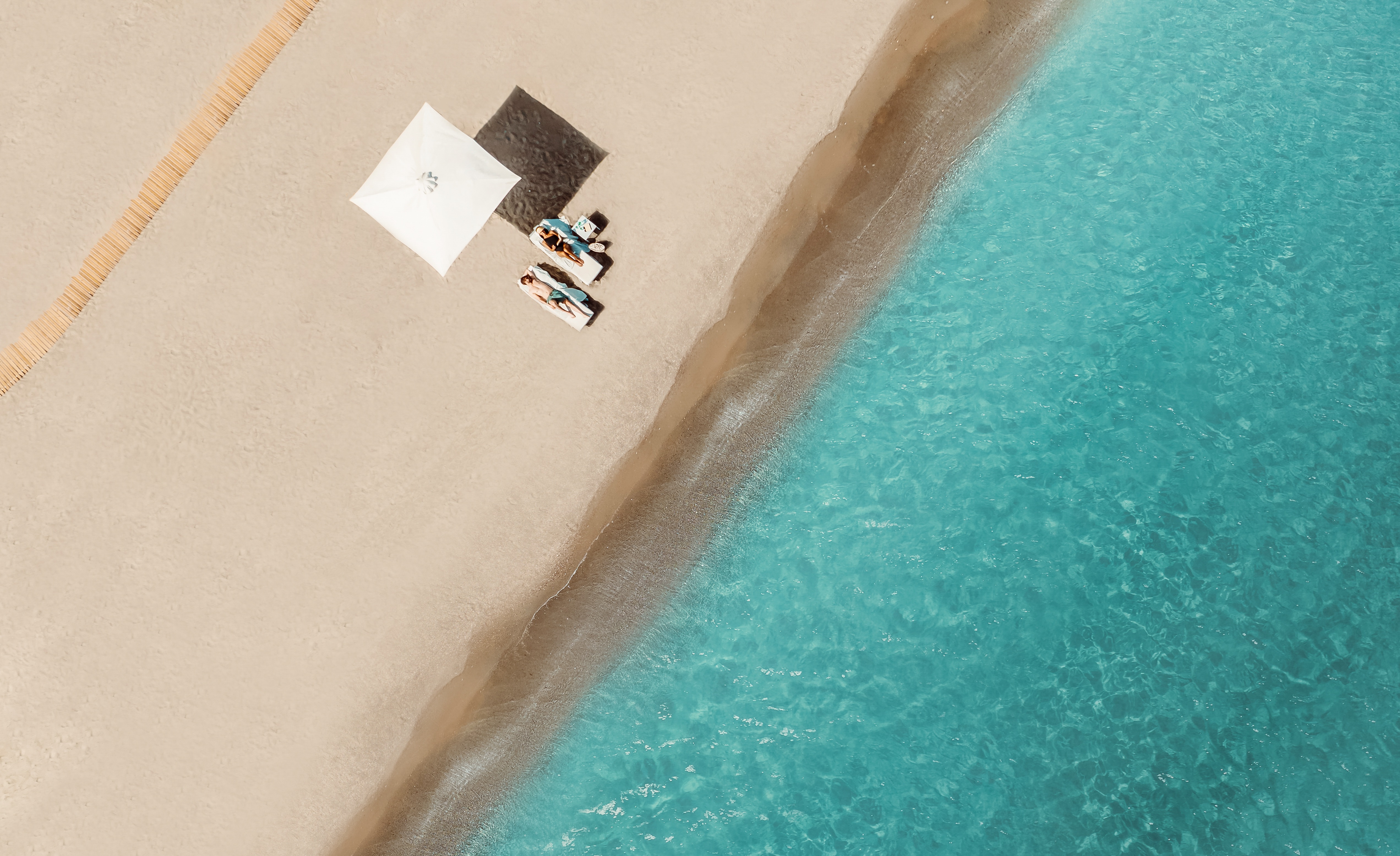 Ikos Resorts_Couple relaxing on the beach